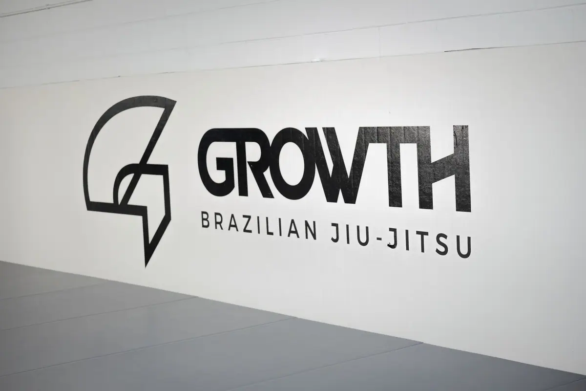 The Growth Brazilian Jiu-Jitsu logo on the academy wall