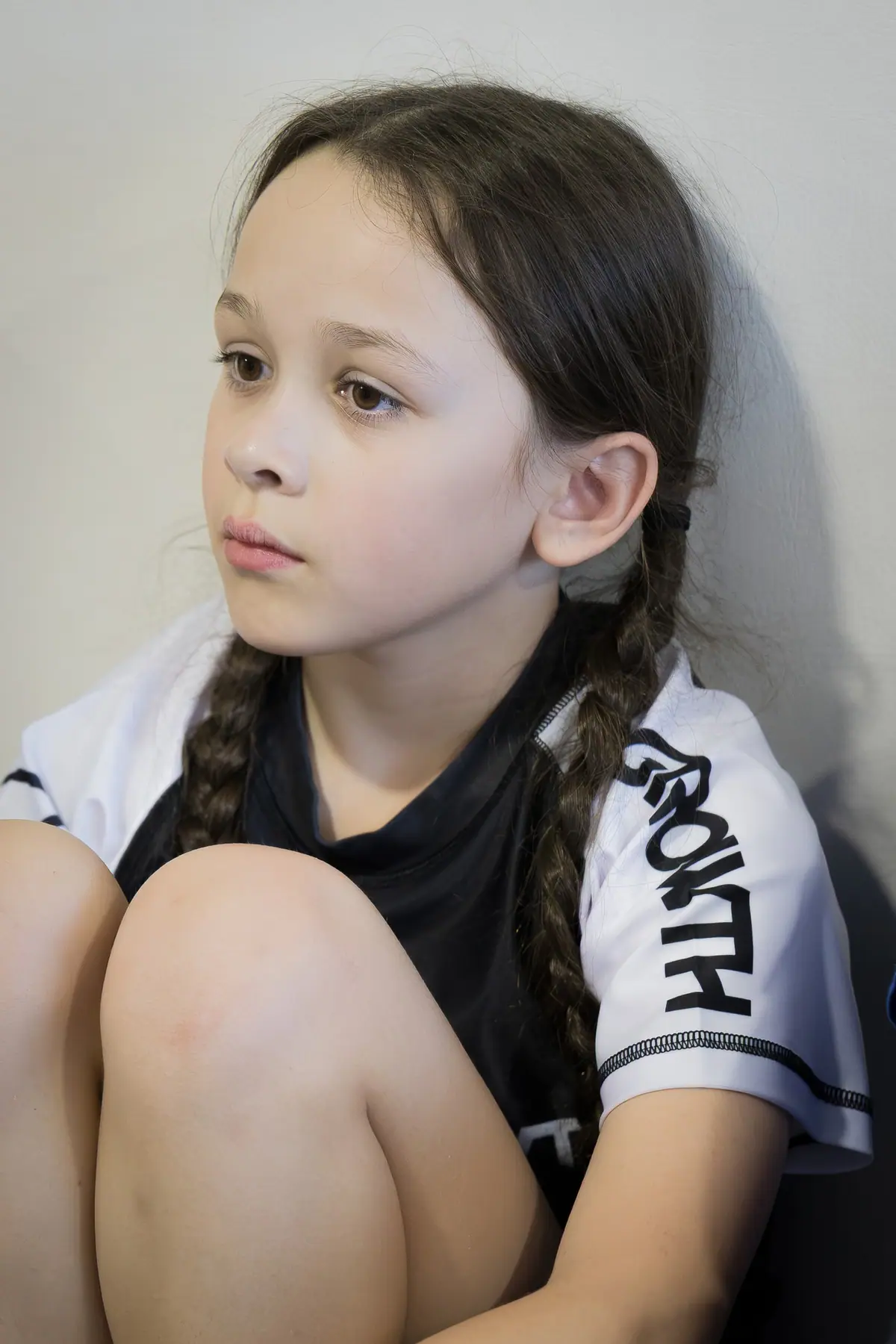 A young girl listening during class