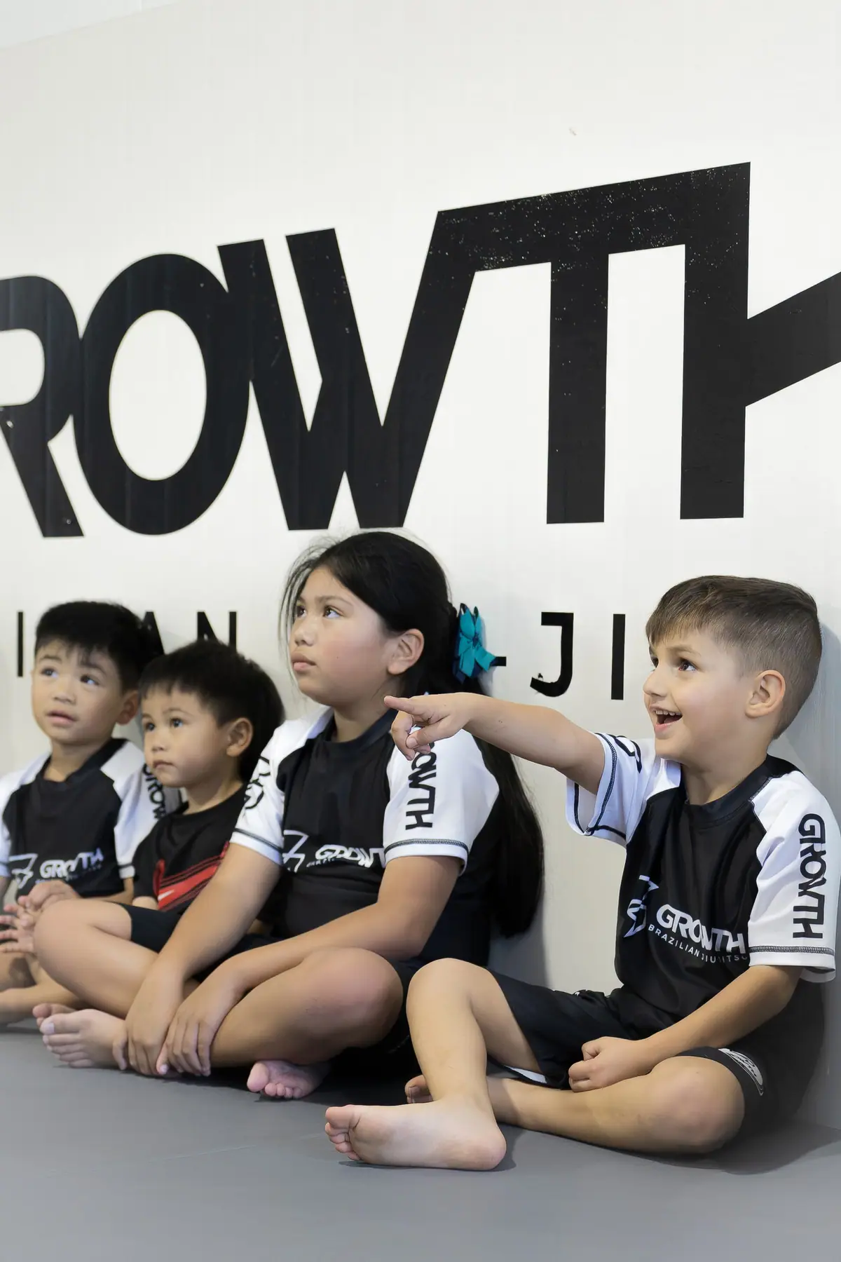 Kids laughing together against the Growth wall