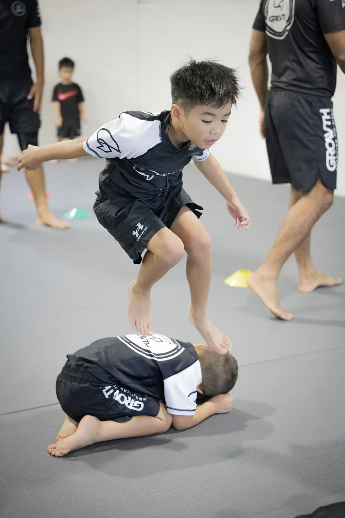 Kids playing leapfrog during the warm-up