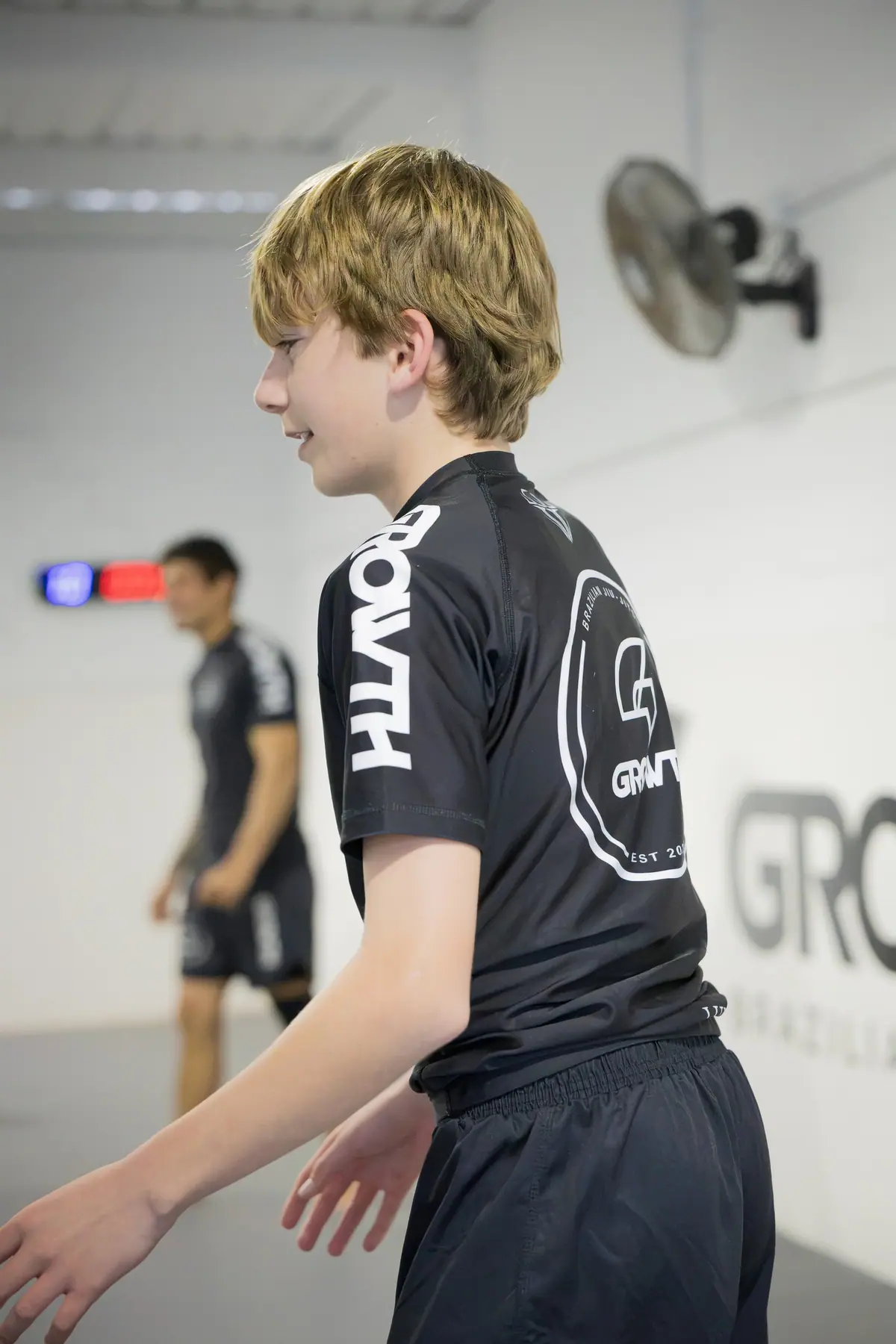 A teenage student laughing with a training partner